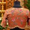 embroidered copper silk blouse on mannequin