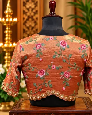 embroidered copper silk blouse on mannequin