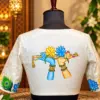 embroidered flute motif blouse in warm studio light