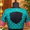teal embroidered open back blouse display