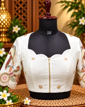 embroidered ivory blouse on mannequin
